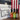 Three bottles of hot sauce in front of a 'Red, White & Burn Box' box with an American flag in the background.